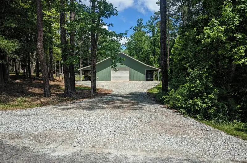 Gravel driveway leading to a home