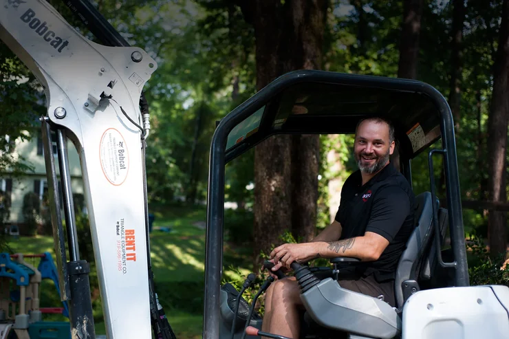 Compact track loader on residential demolition site